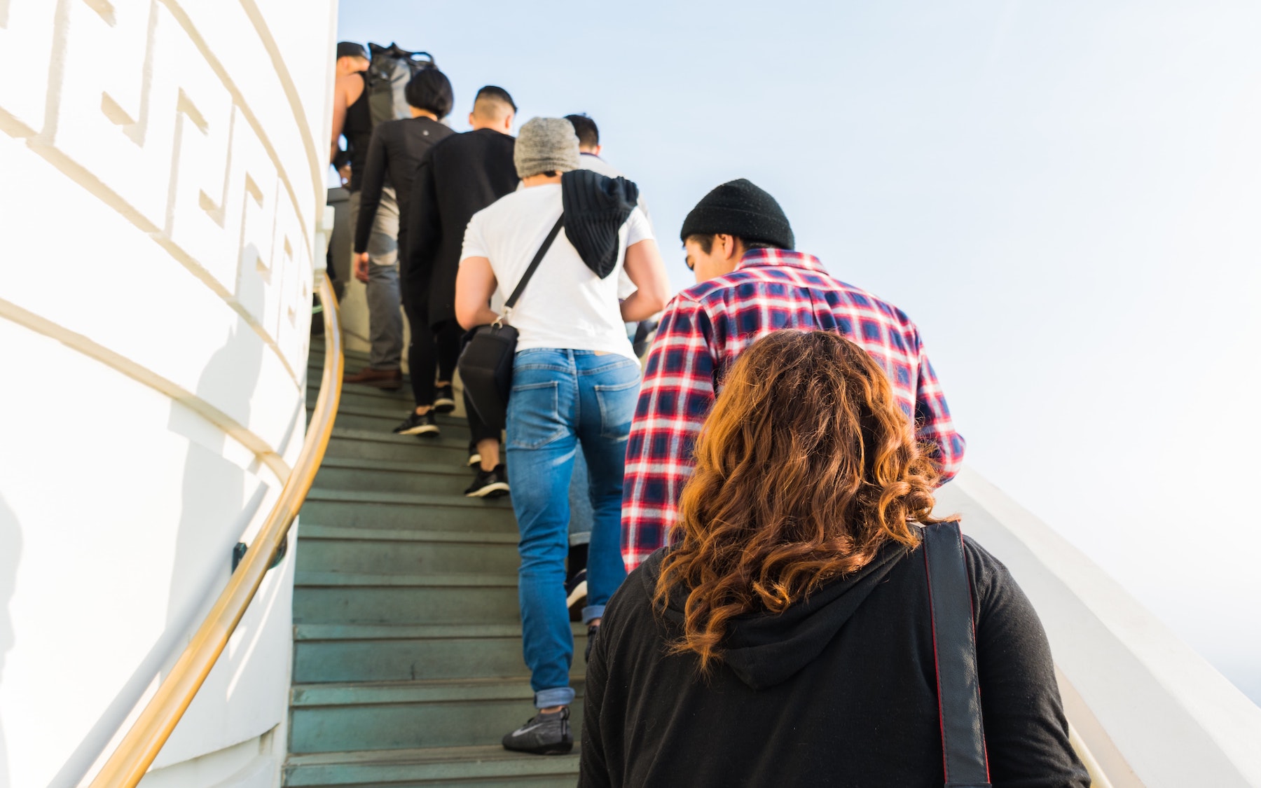 People in single file climbing steps