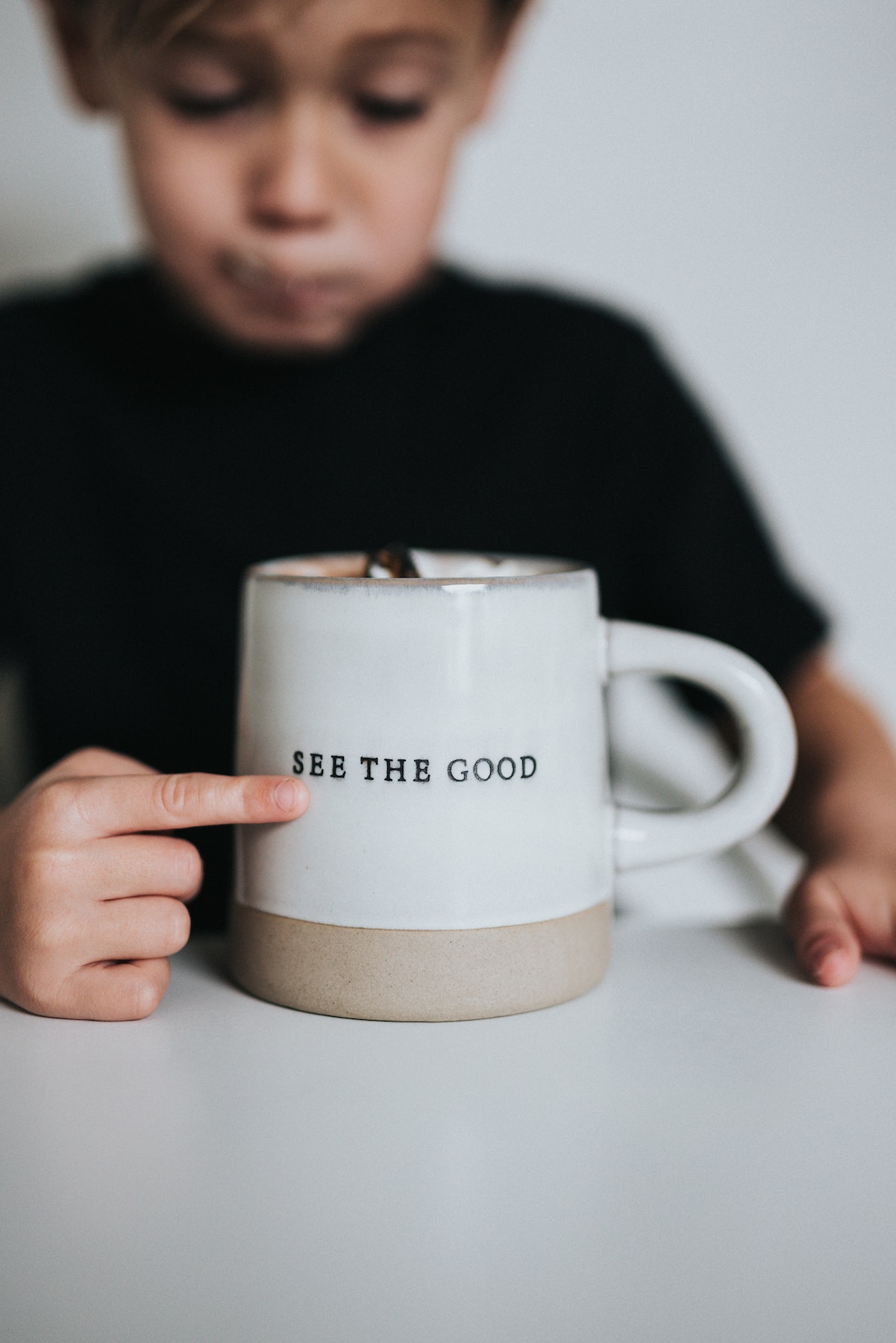 Boy with a cup saying see the good